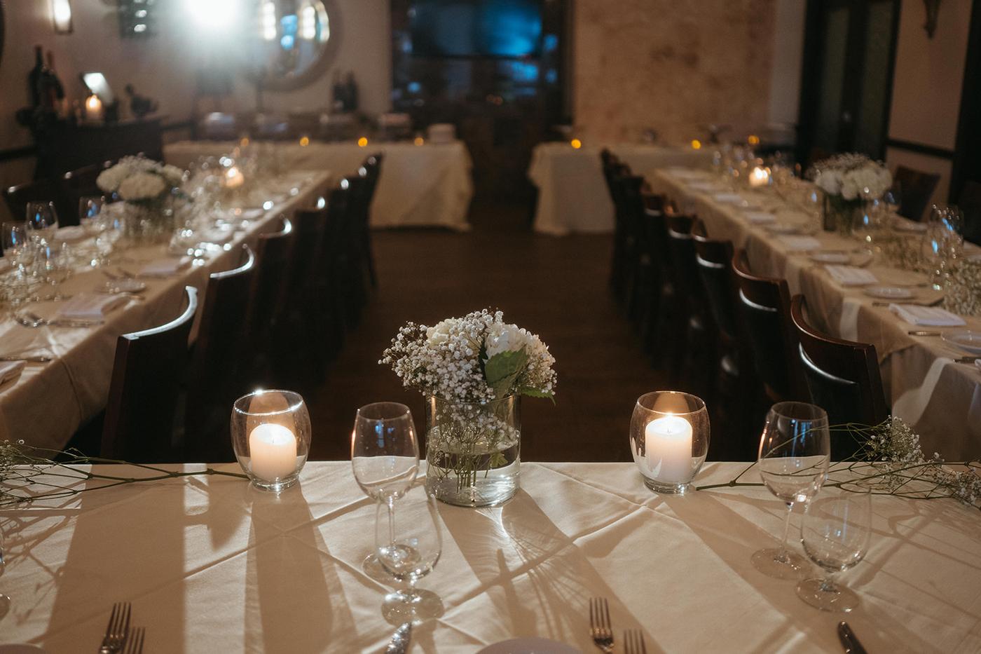 Candlelit table with flowers for rehearsal dinner