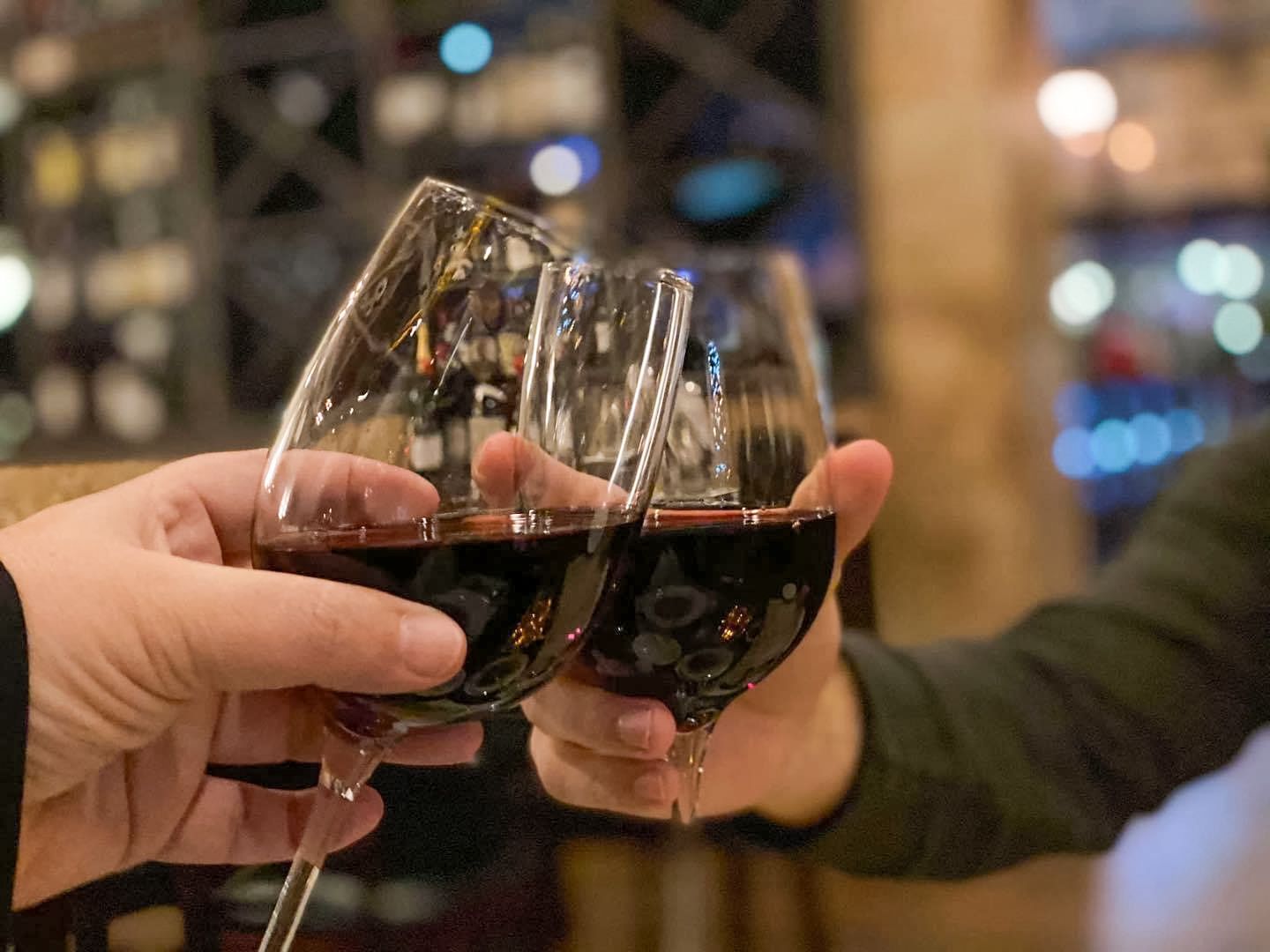 Wine glasses clinking at Vincenzo happy hour
